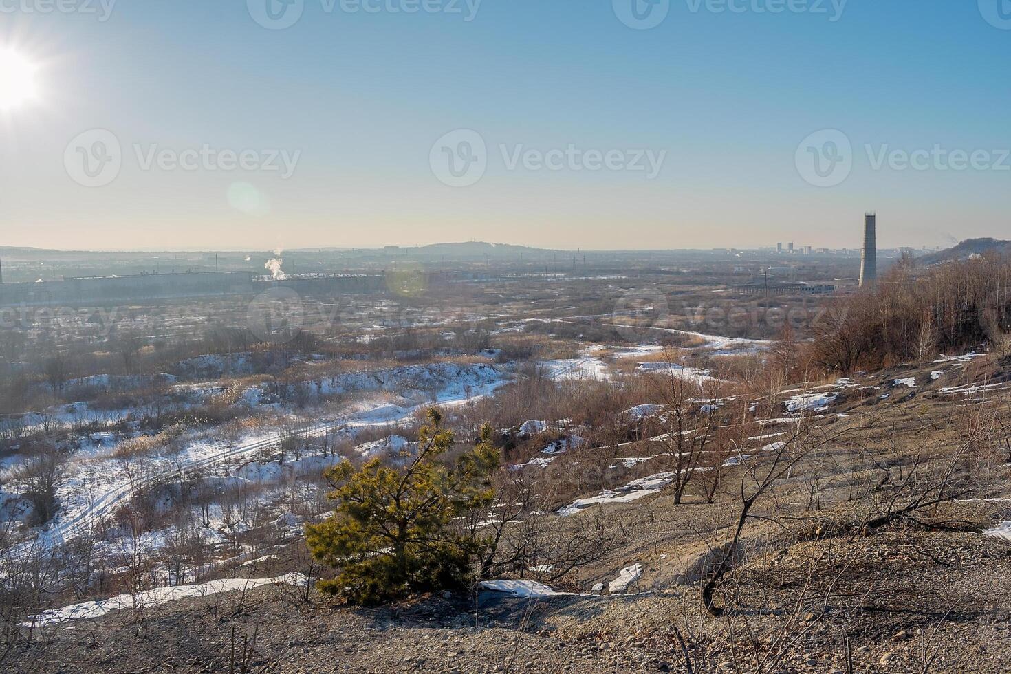 Winter landscape. View from the hill to the lowland where the small town of Ussuriysk is located in Russia. Winter day with clear sky. photo