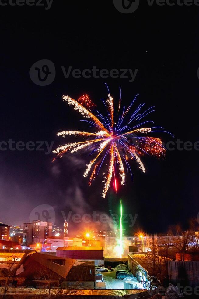 Fireworks in a residential area of Vladivostok in Russia. New Year celebrations in a poor area of a provincial town in Russia. photo
