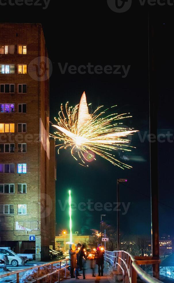 Fireworks in a residential area of Vladivostok in Russia. New Year celebrations in a poor area of a provincial town in Russia. photo