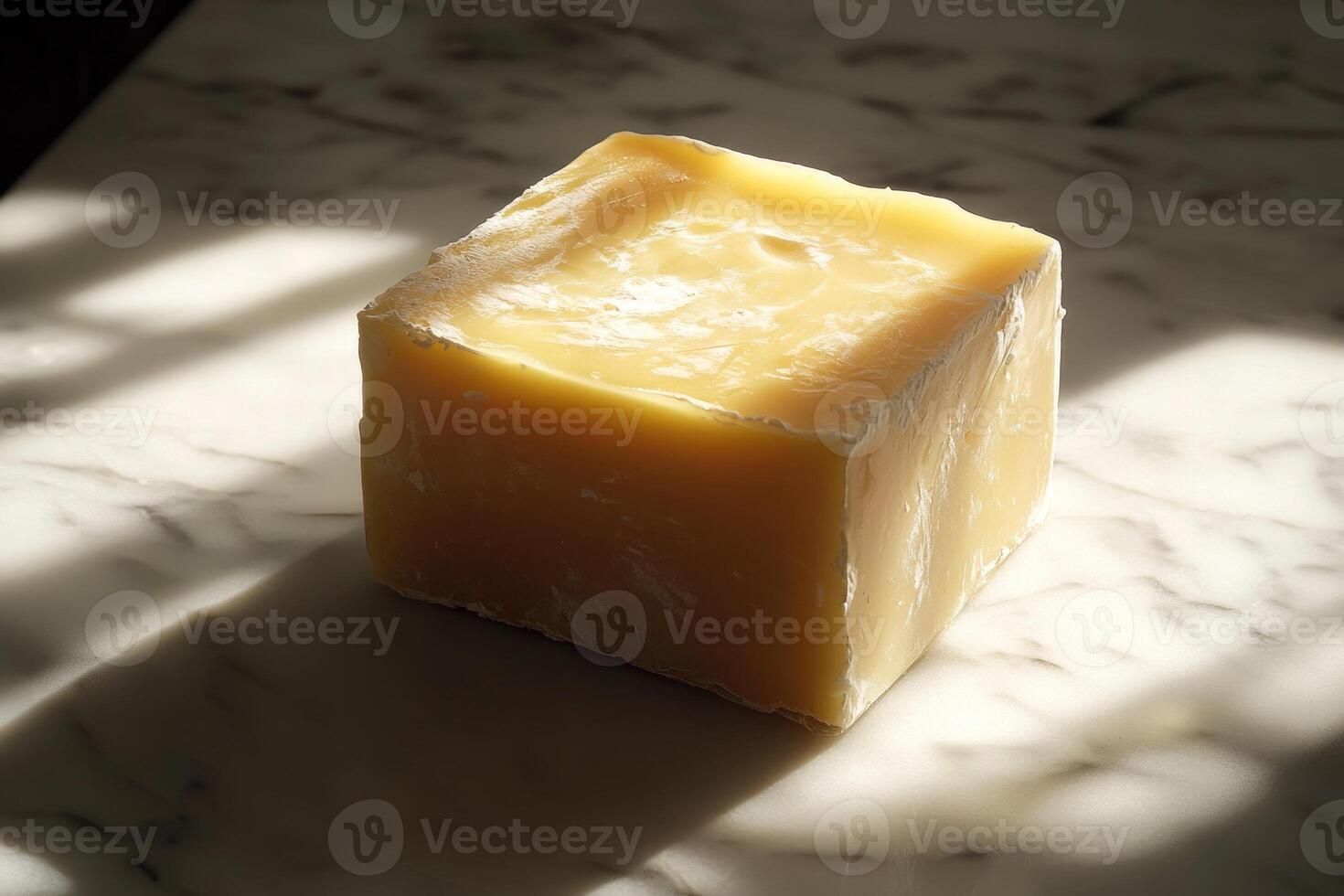 A Block of Pale Yellow Wax on a Marble Surface photo