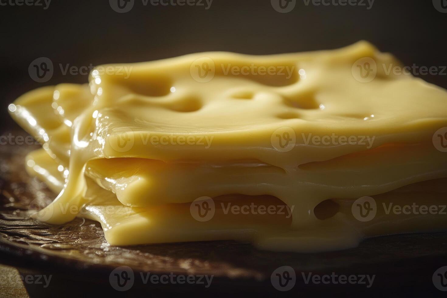 Melted Slices of Swiss Cheese on a Wooden Plate photo