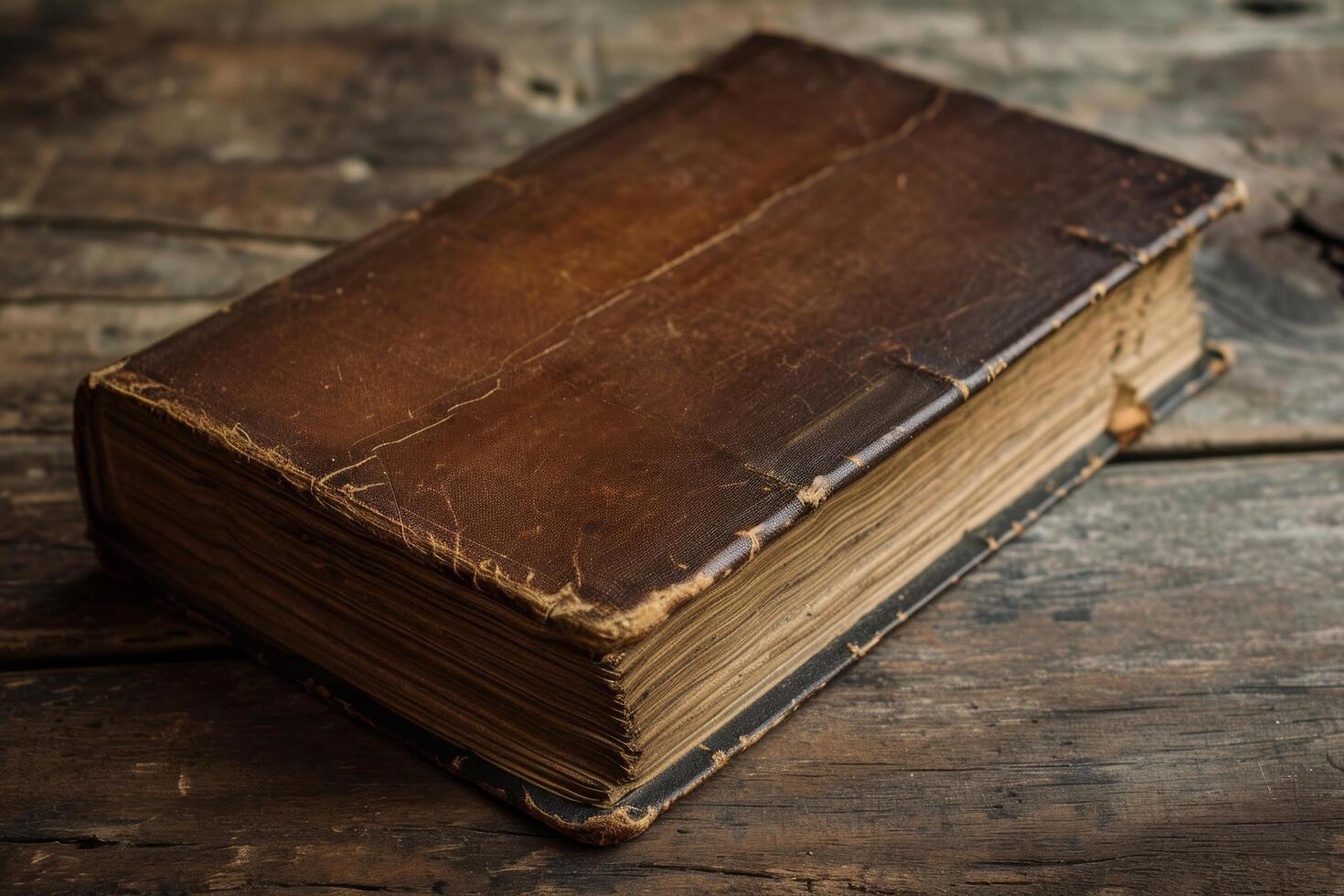 Antique leather bound book on a wooden table photo