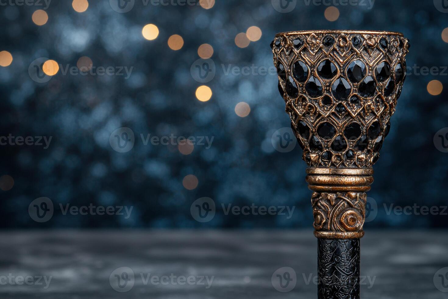 Ornate golden chalice against a blurry background of twinkling lights photo