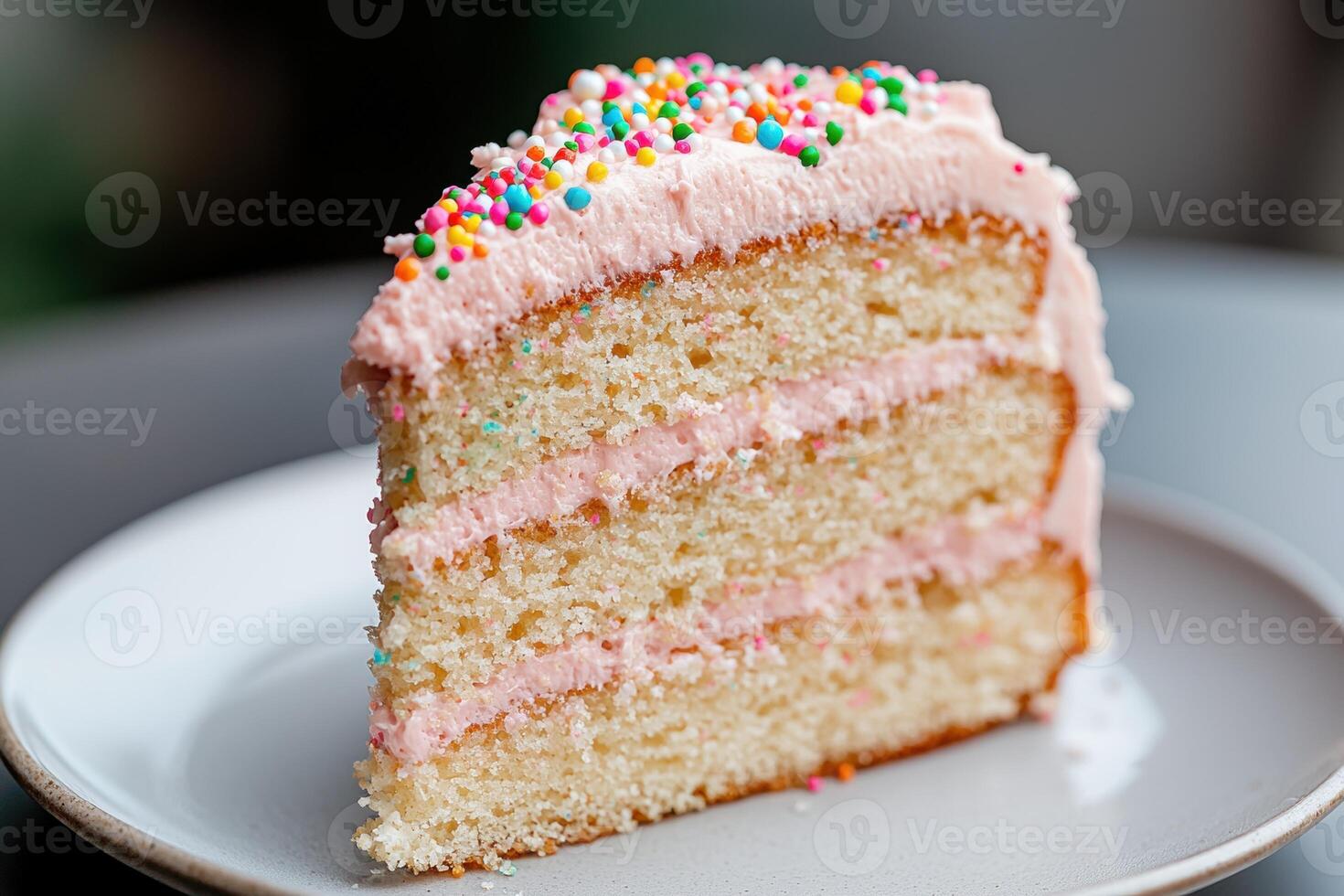 Colorful sprinkle topped cake slice on plate photo