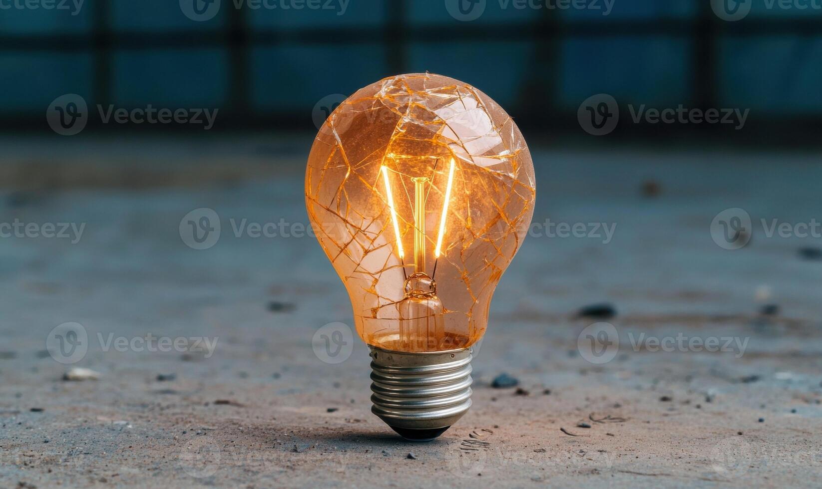 Glowing vintage light bulb on concrete surface photo