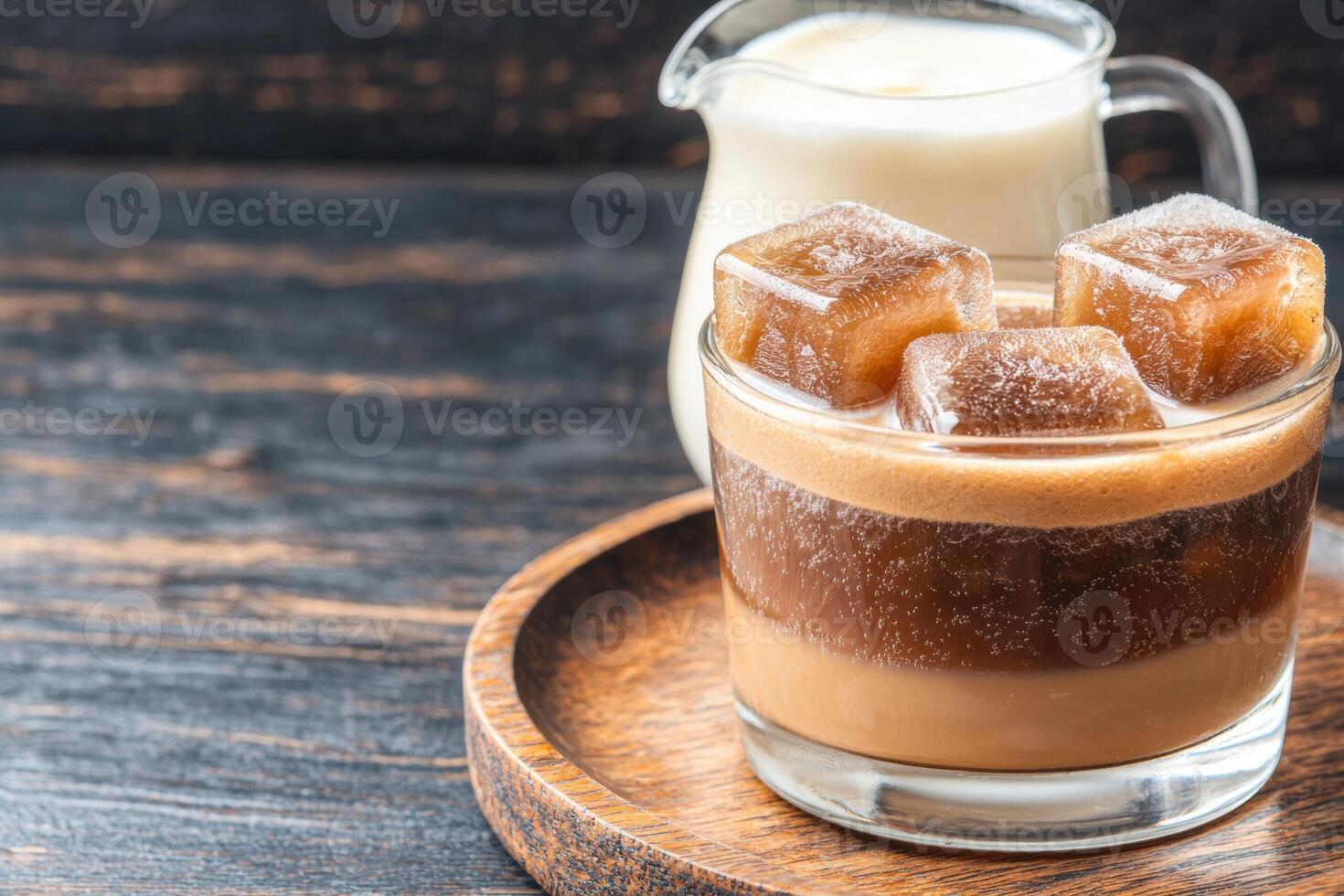 Creamy cold brew coffee with ice cubes and caramel candy photo