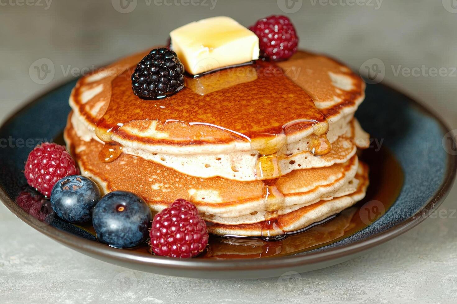 Delicious stack of fluffy pancakes with fresh berries and butter photo