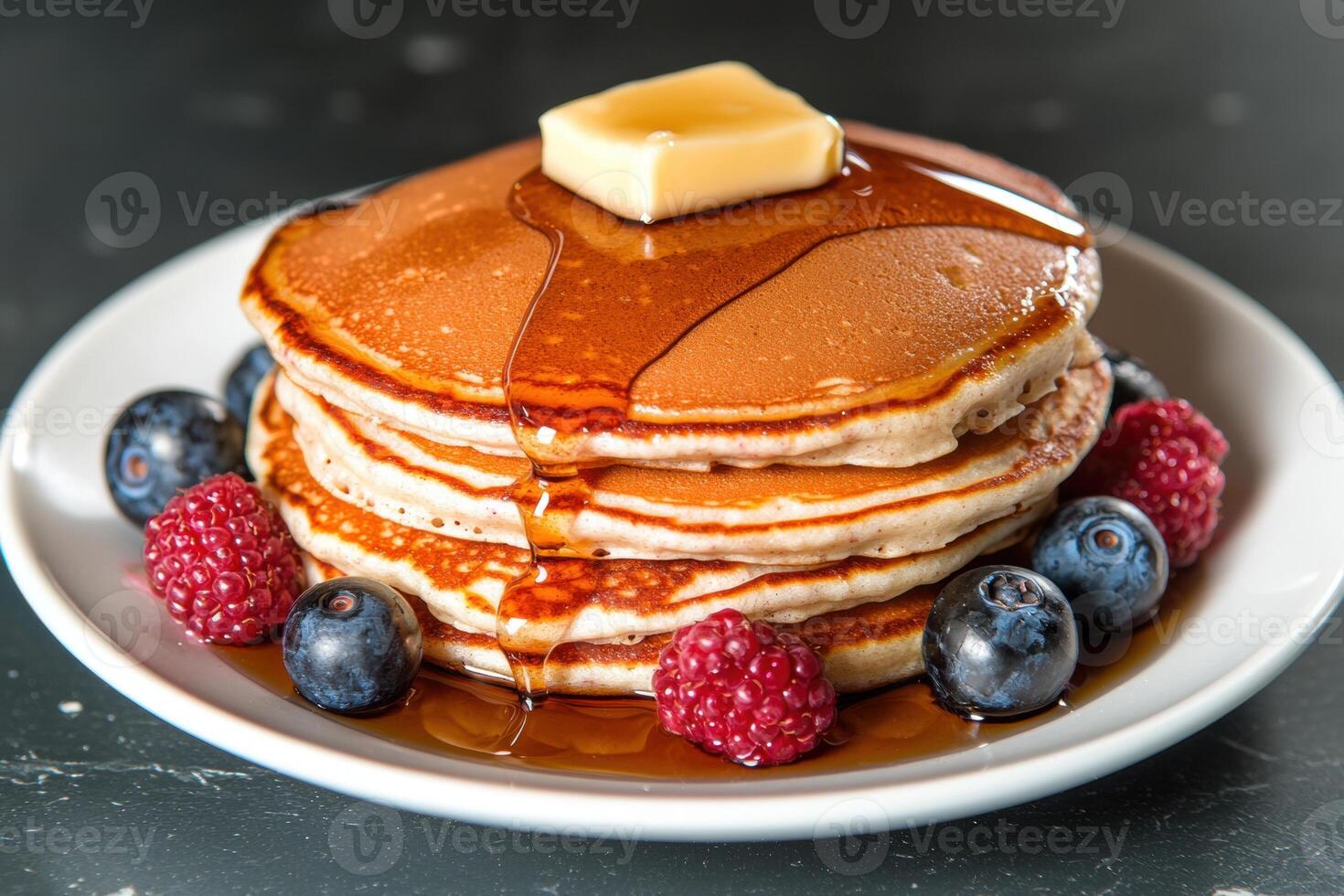 Delicious golden pancakes with butter and syrup photo