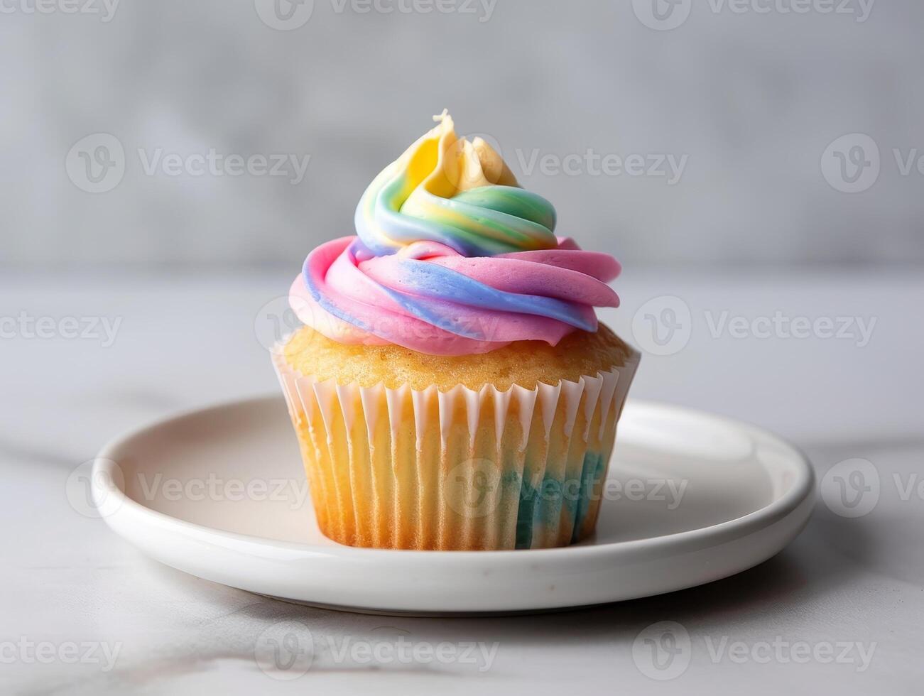 colorful swirled cupcake on white plate photo