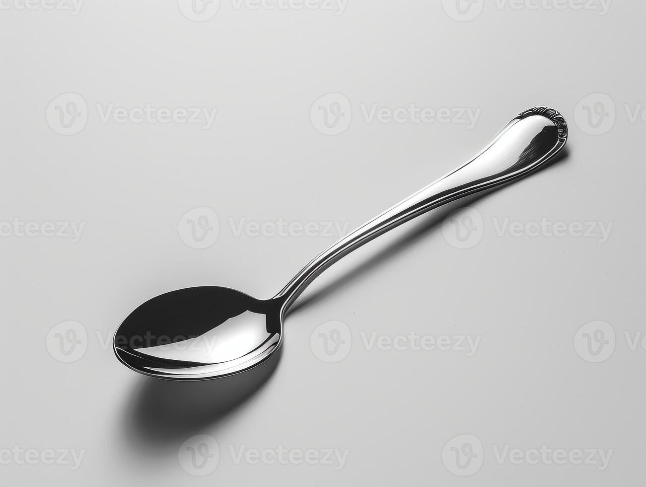 Elegant metal spoon on a minimalist background photo