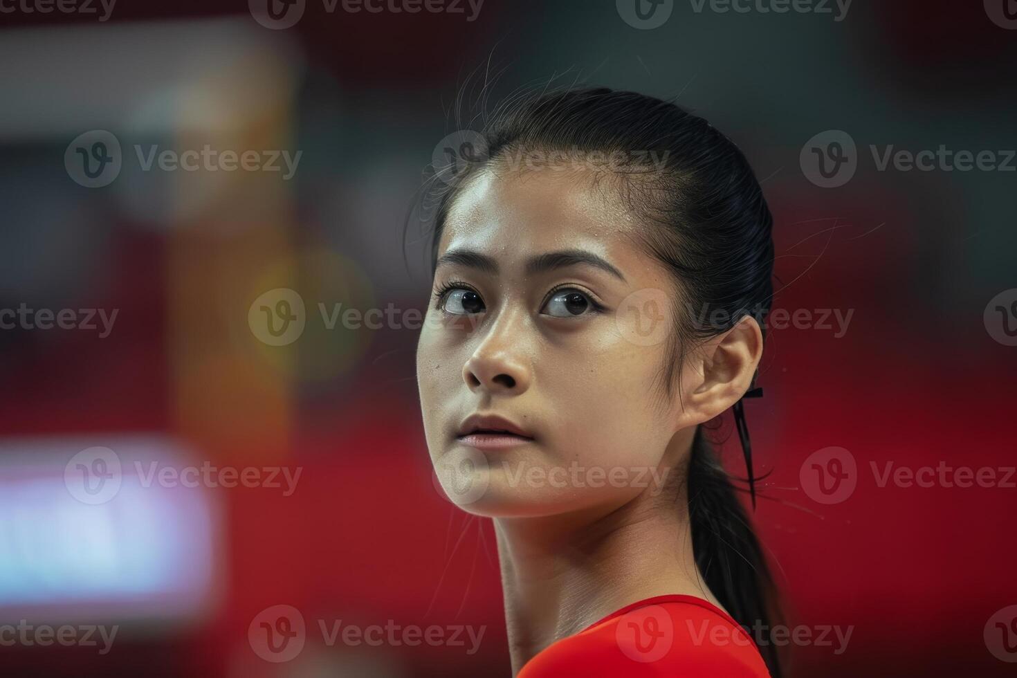 Thoughtful young asian woman in red shirt photo