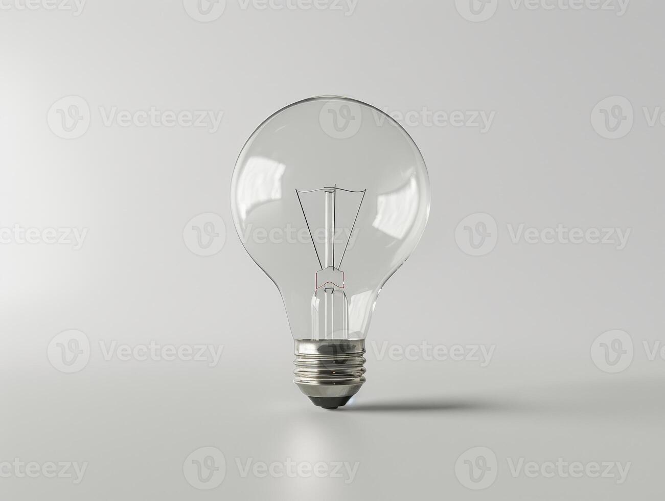Illuminating idea a clear light bulb on a plain background photo