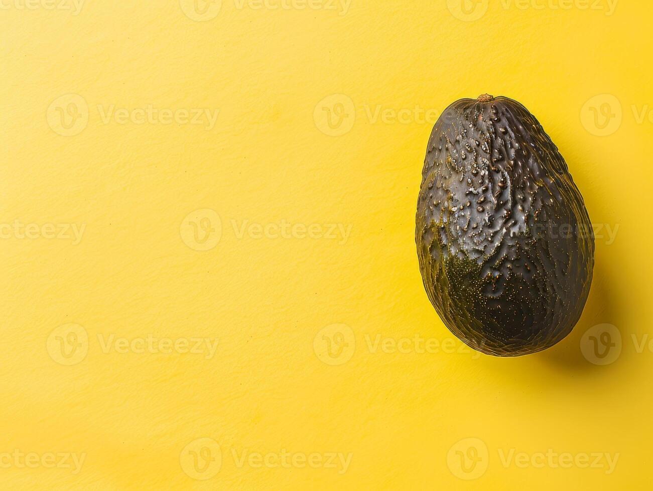 Ripe avocado on yellow background photo