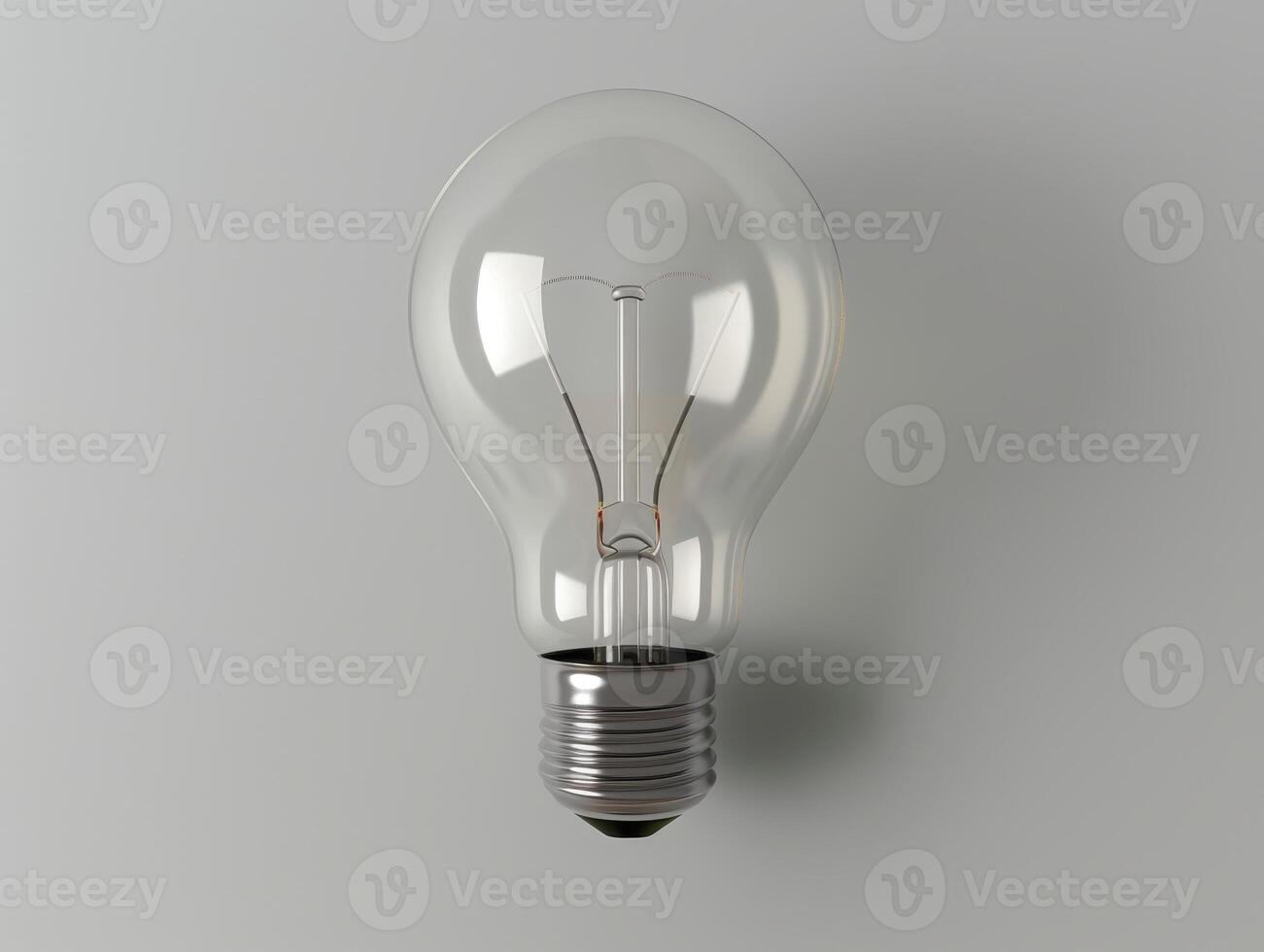 Glowing light bulb against a gray background photo