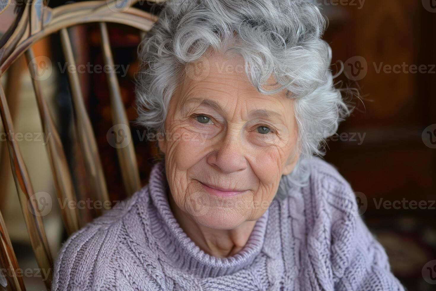 smiling elderly woman with curly gray hair photo