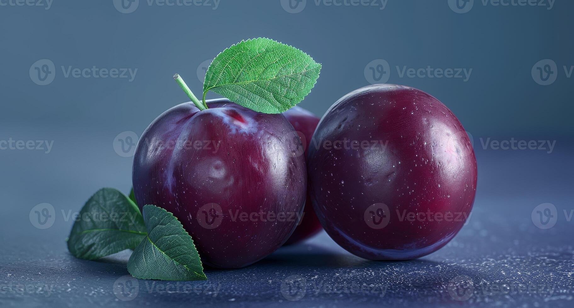 Ripe plums with green leaves on dark background photo