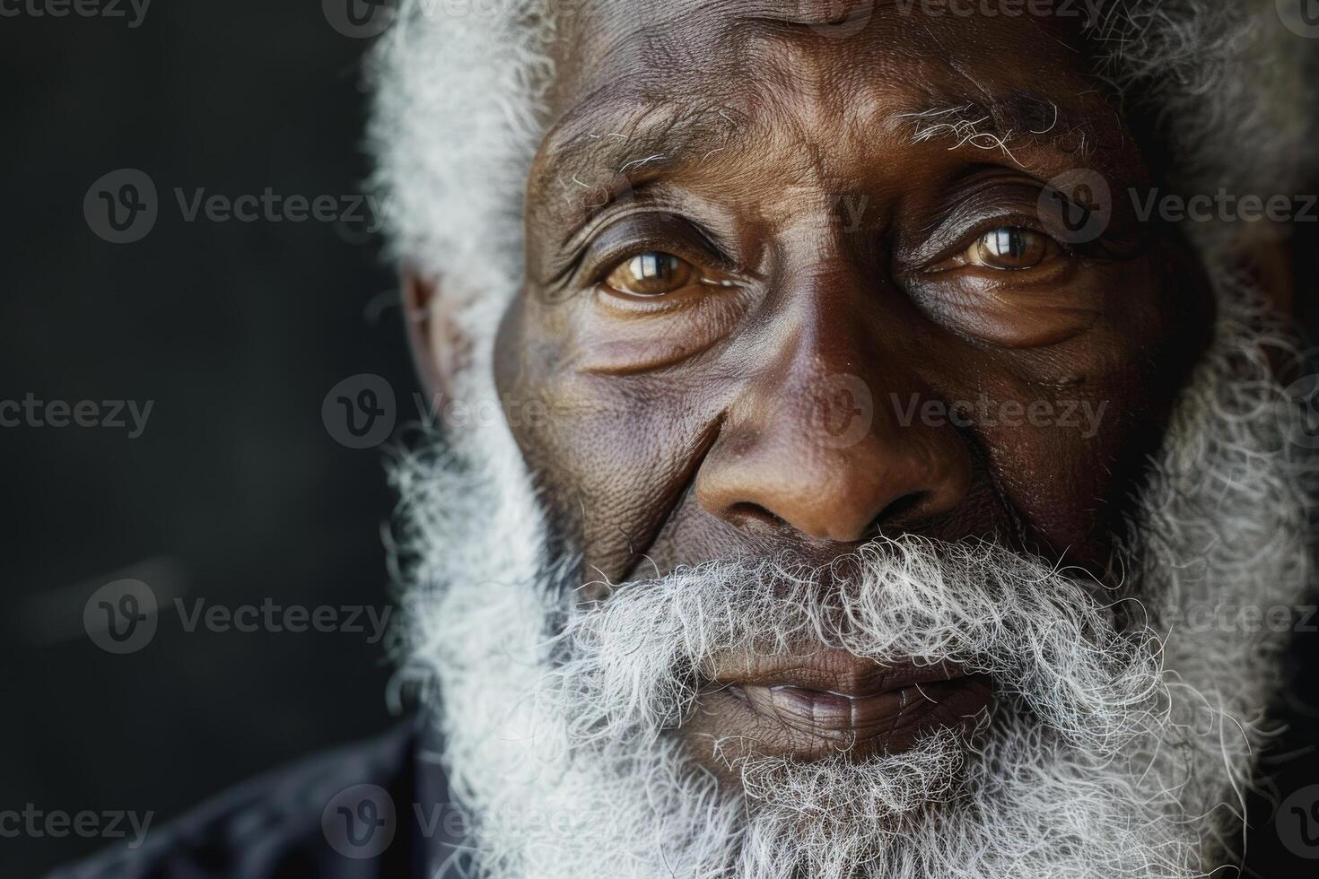 Weathered face of an elderly man with a long white beard photo