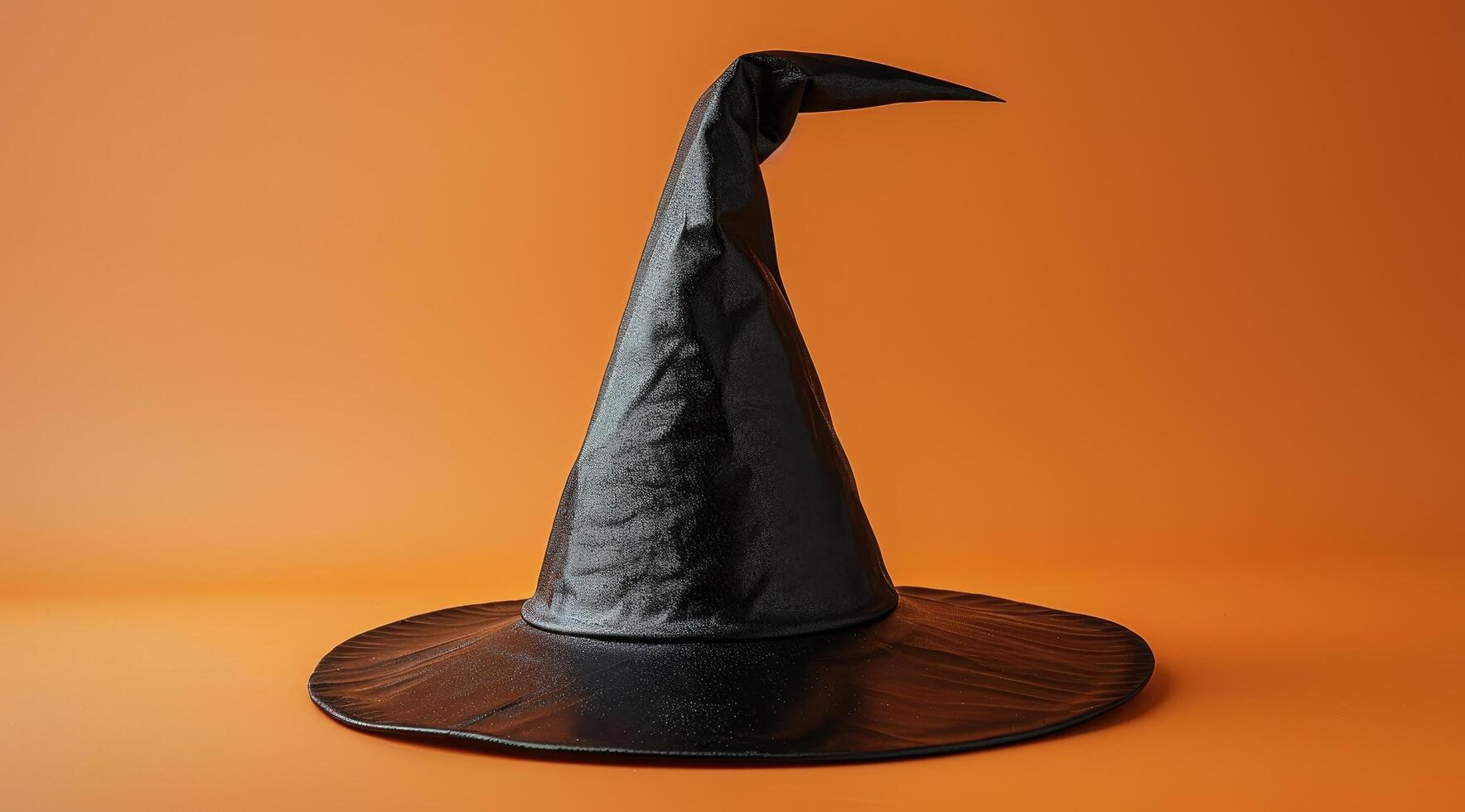 Witchs hat on orange background photo
