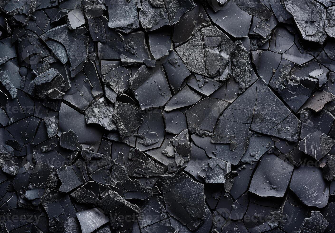 Close up of a cracked and textured dark surface photo