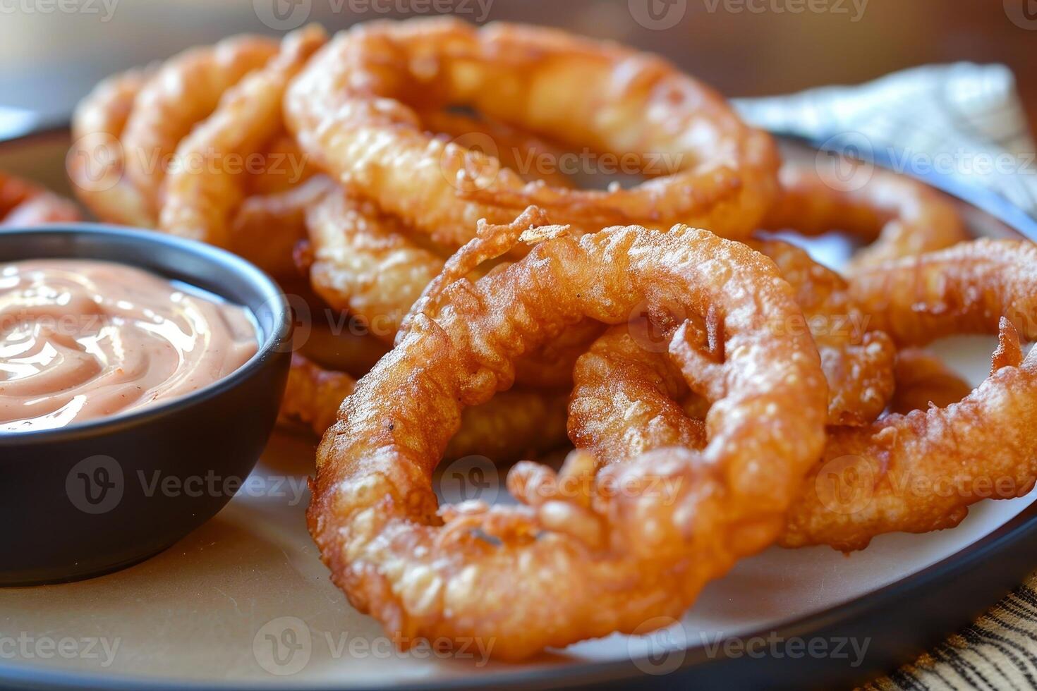 Crispy fried onion rings served with dipping sauce photo