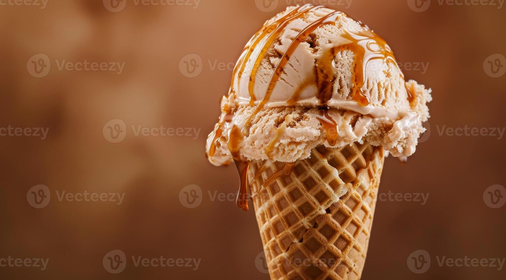 Delicious caramel drizzled ice cream cone on a warm day photo