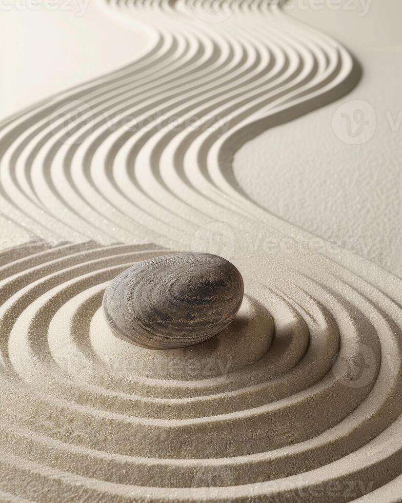 Zen stone in sand with ripple pattern photo