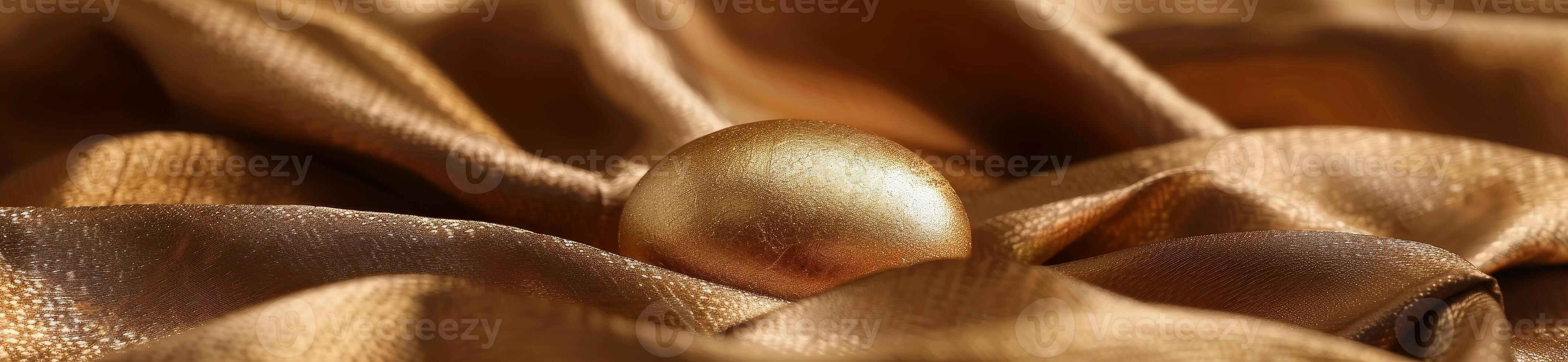 Golden egg nestled in luxurious golden fabric photo
