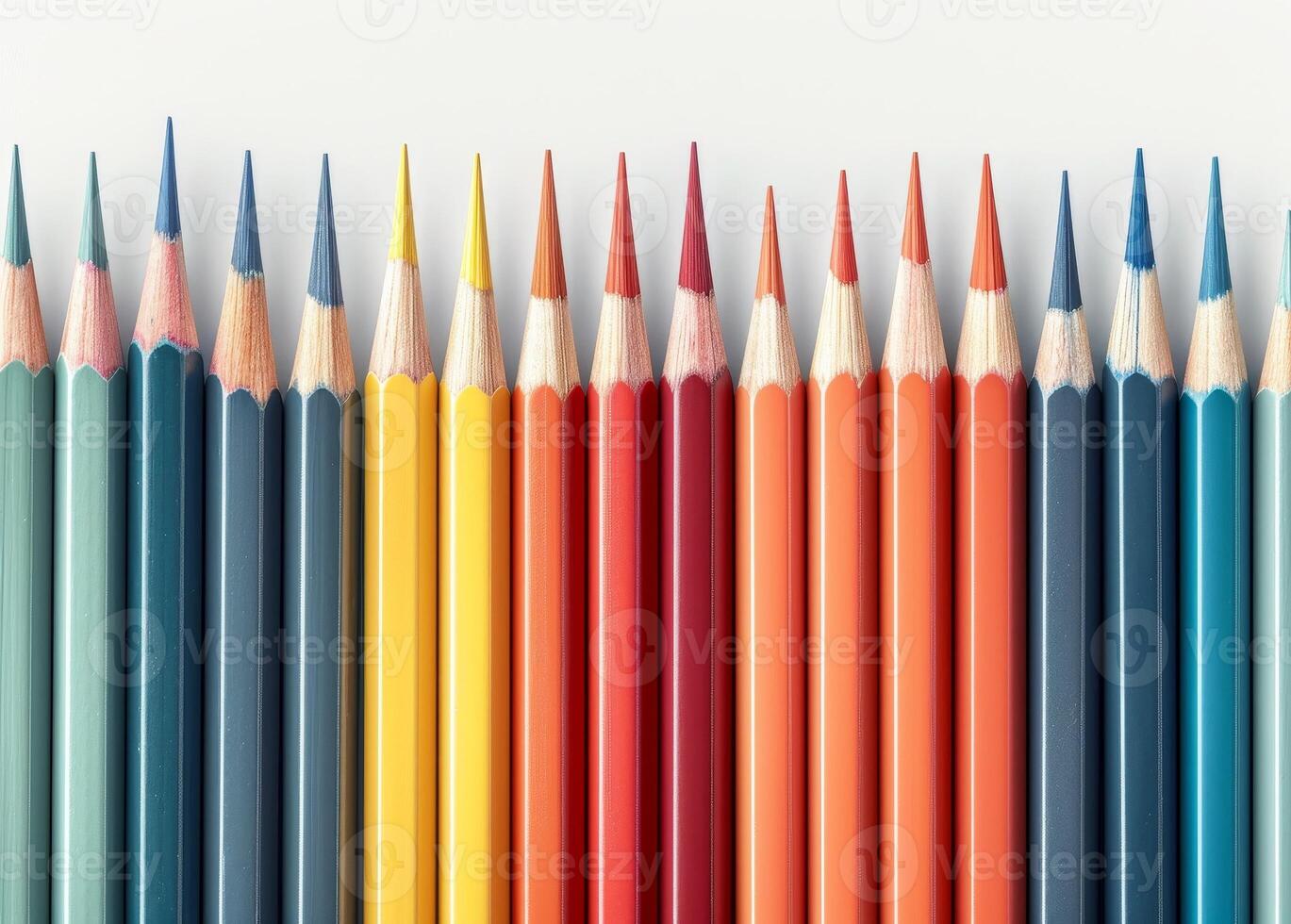Colorful array of sharpened pencils lined up against a white background photo