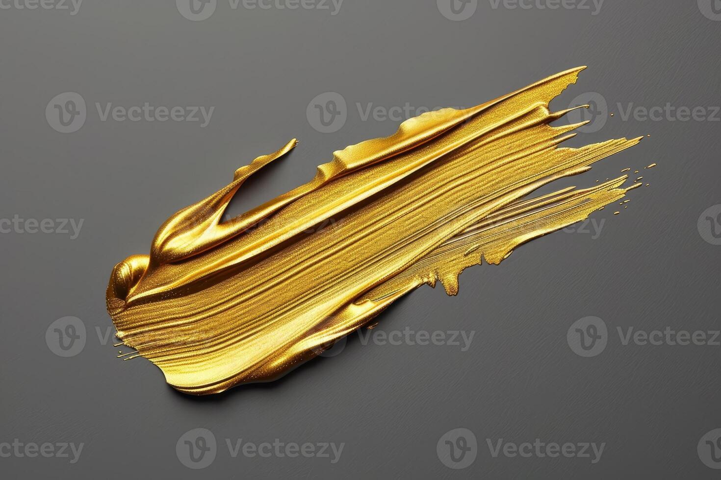 Golden paint smear on a gray background photo