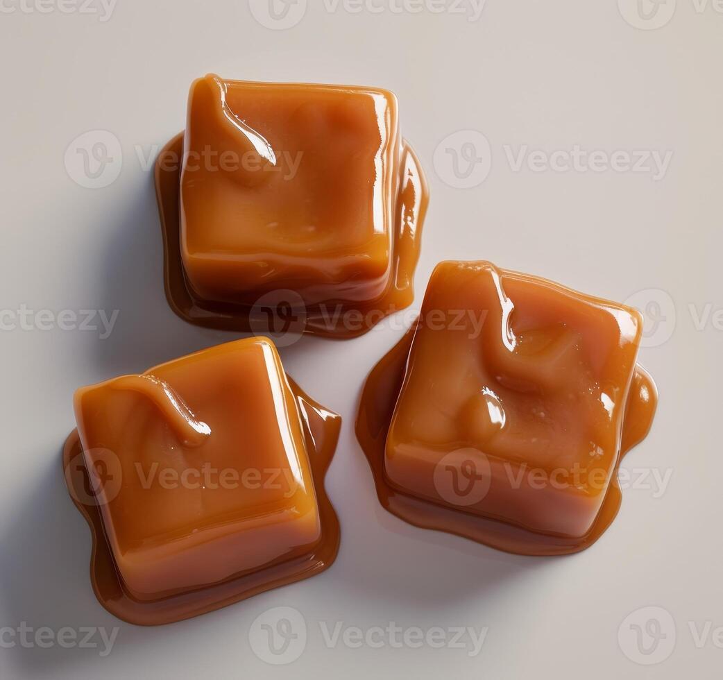 Glossy caramel candies on a smooth surface photo