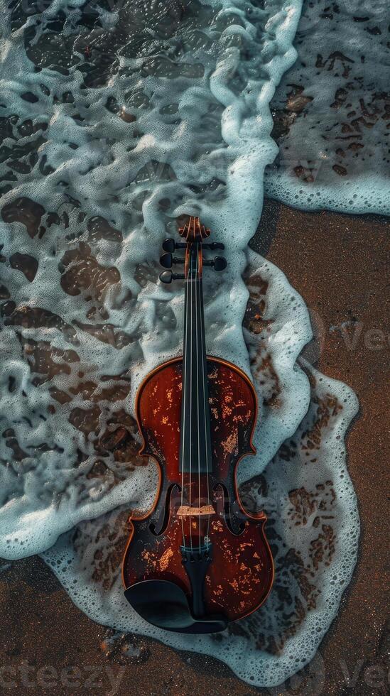 Violin washed by ocean waves on sandy beach photo