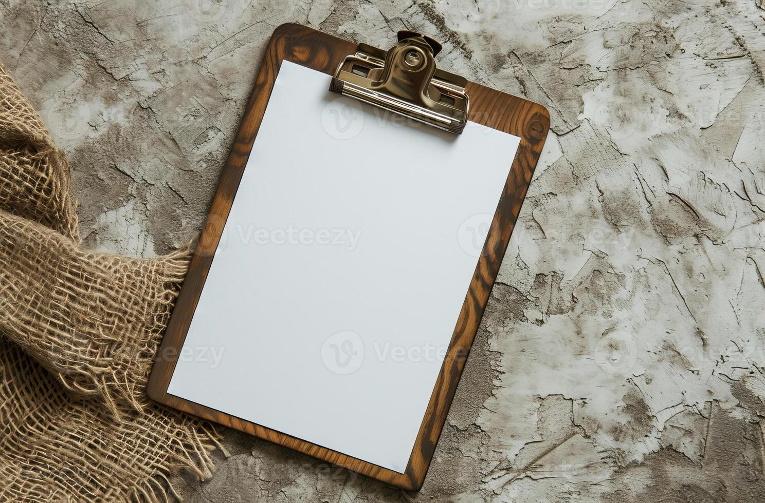 Blank clipboard on a textured background with burlap fabric photo