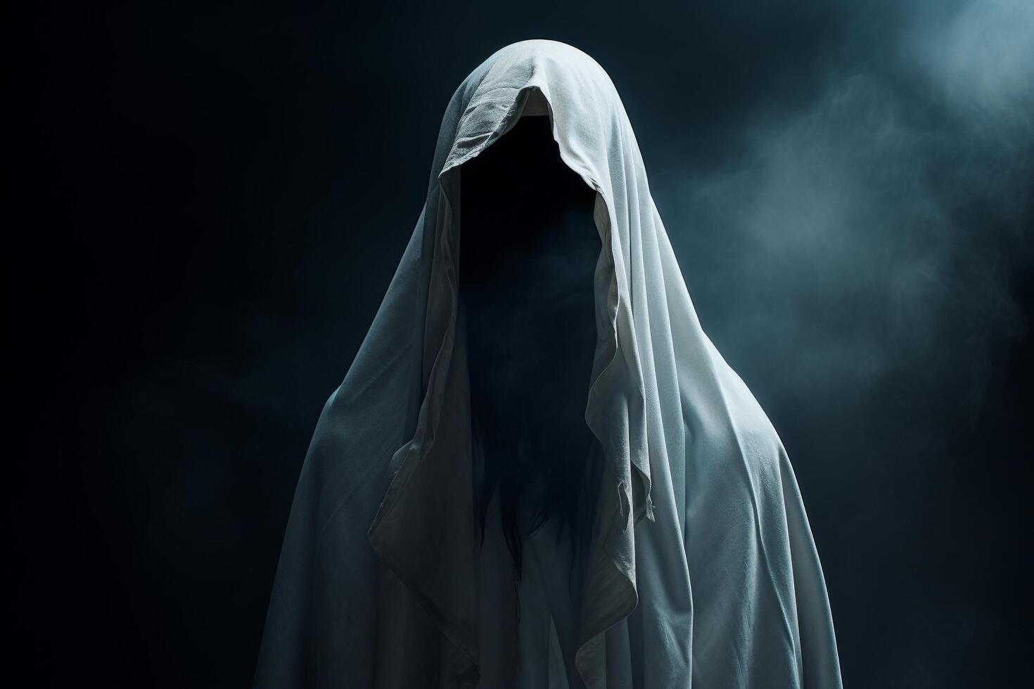 Mysterious figure shrouded in a white cloak against a dark background photo