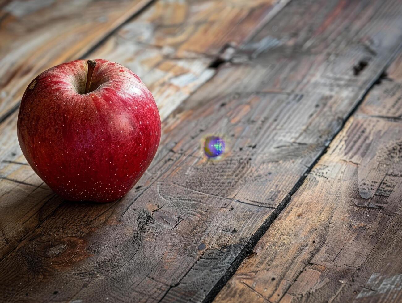 Fresh red apple on rustic wooden table photo