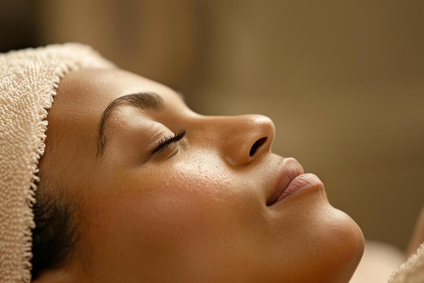 Woman relaxing with eyes closed and towel on head photo