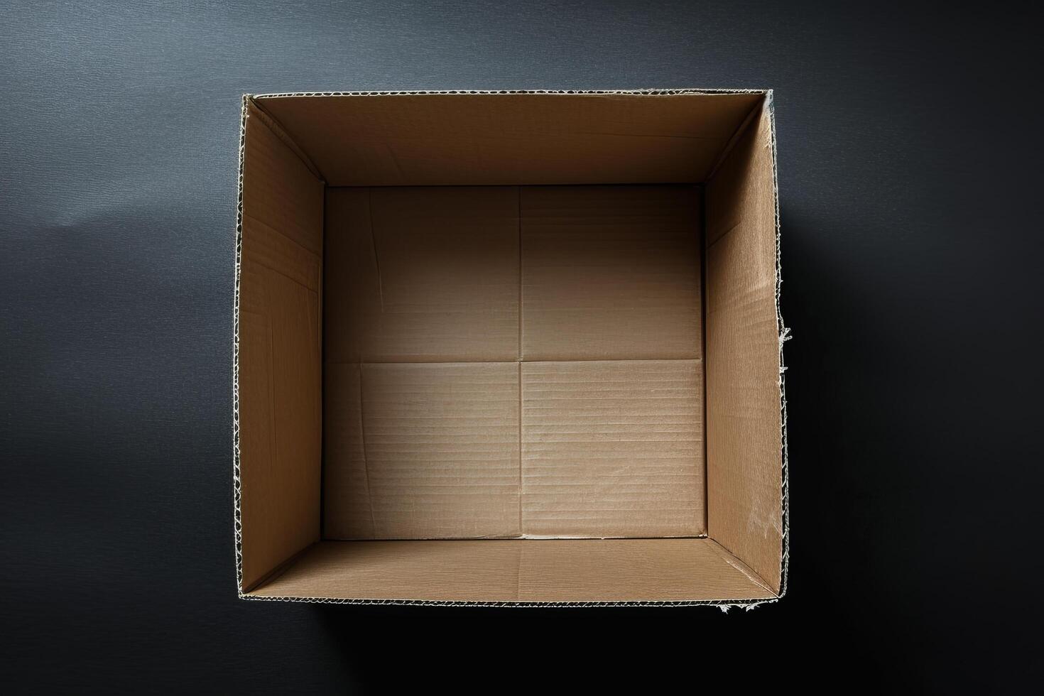 Empty cardboard box on a dark background photo