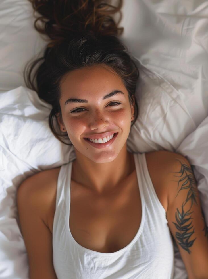 Young woman smiling while lying in bed photo