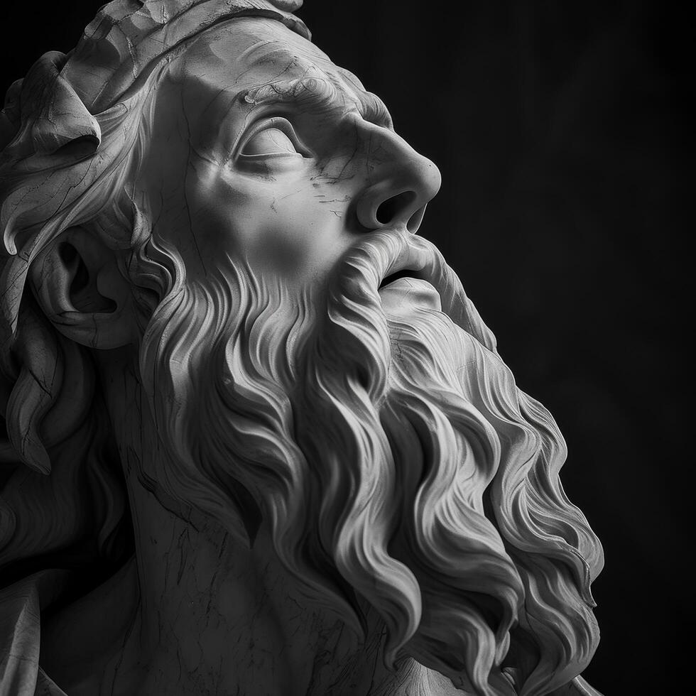 Dramatic black and white sculpture of a bearded man looking upwards photo