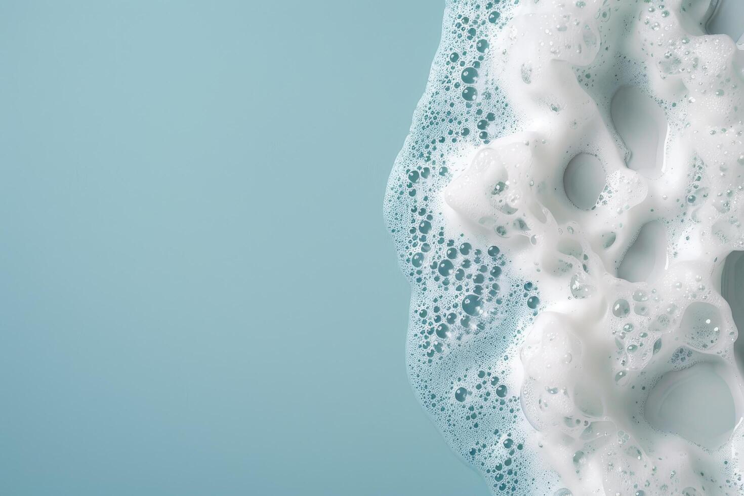 Close up of gentle foamy soap bubbles on a soft blue background photo