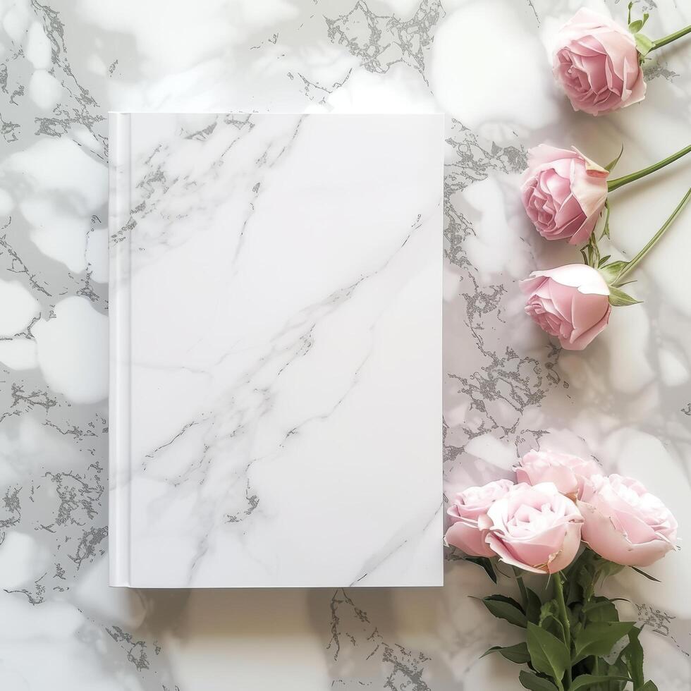 Elegant notebook with pink roses on a marble background photo