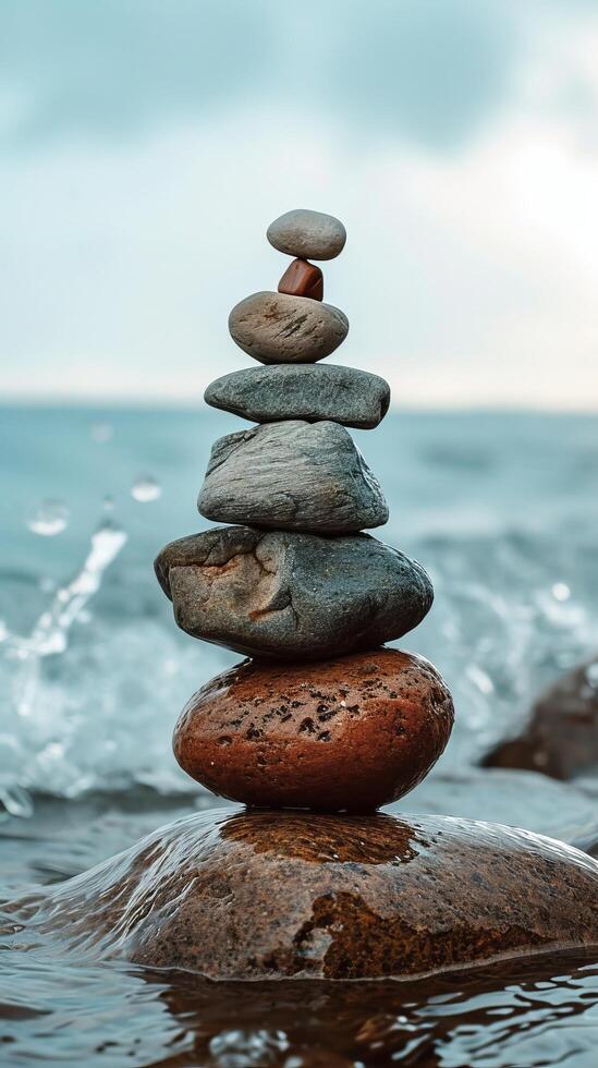 Zen stones stacked by the sea for balance and harmony photo