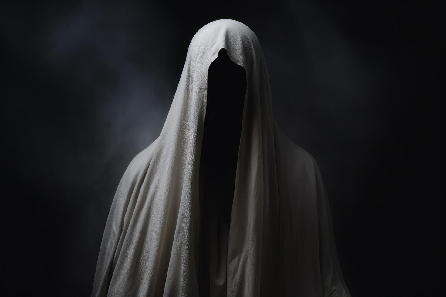 Mysterious figure shrouded in a white cloak against a dark background photo