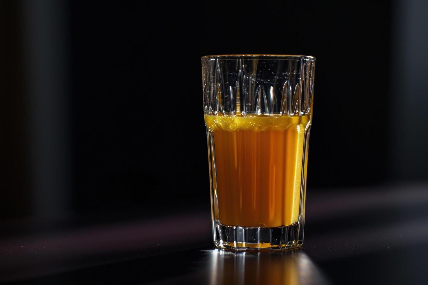 a glass of orange liquid photo