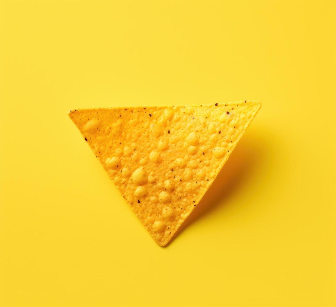 a yellow tortilla chip on a yellow background photo