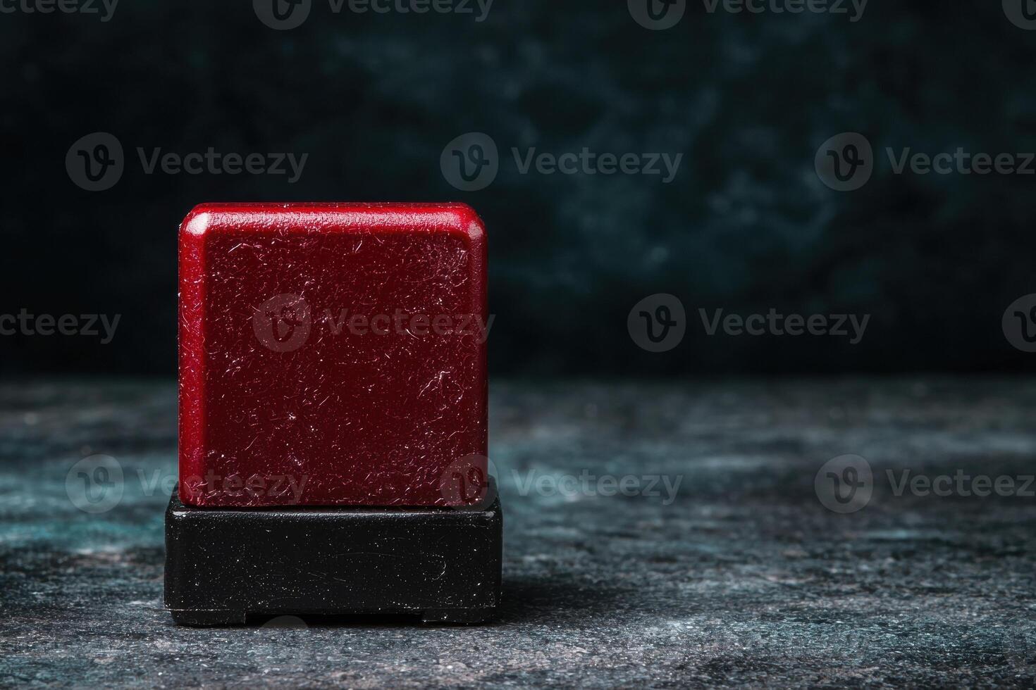 Vibrant red soap bar on dark background photo