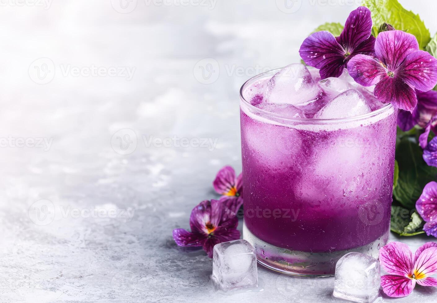 Refreshing purple cocktail with ice and flowers photo