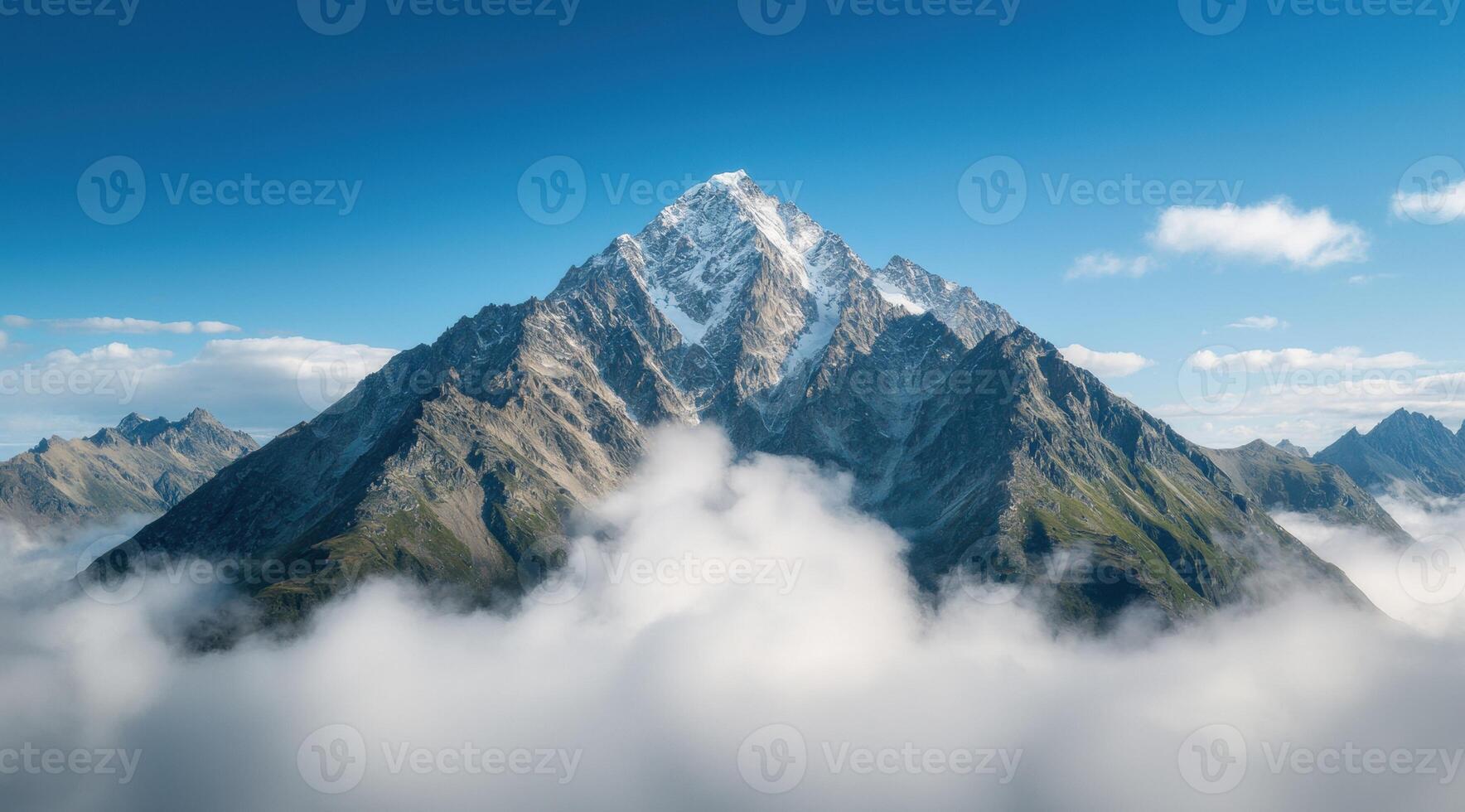 Majestic snow capped mountain peak in the clouds photo