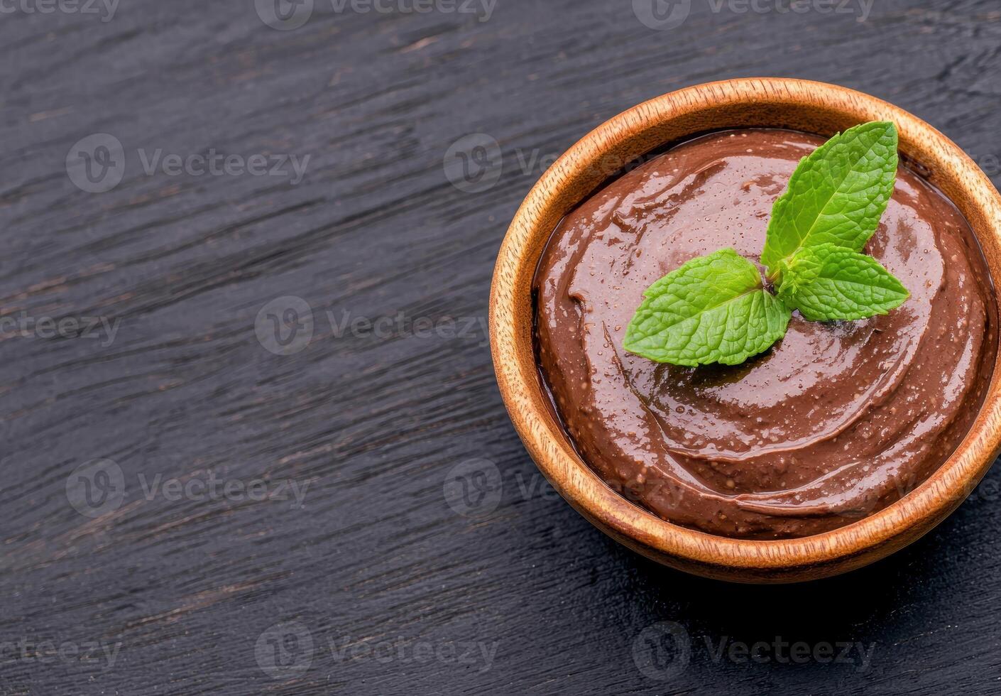 Delicious chocolate mousse dessert in a wooden bowl photo