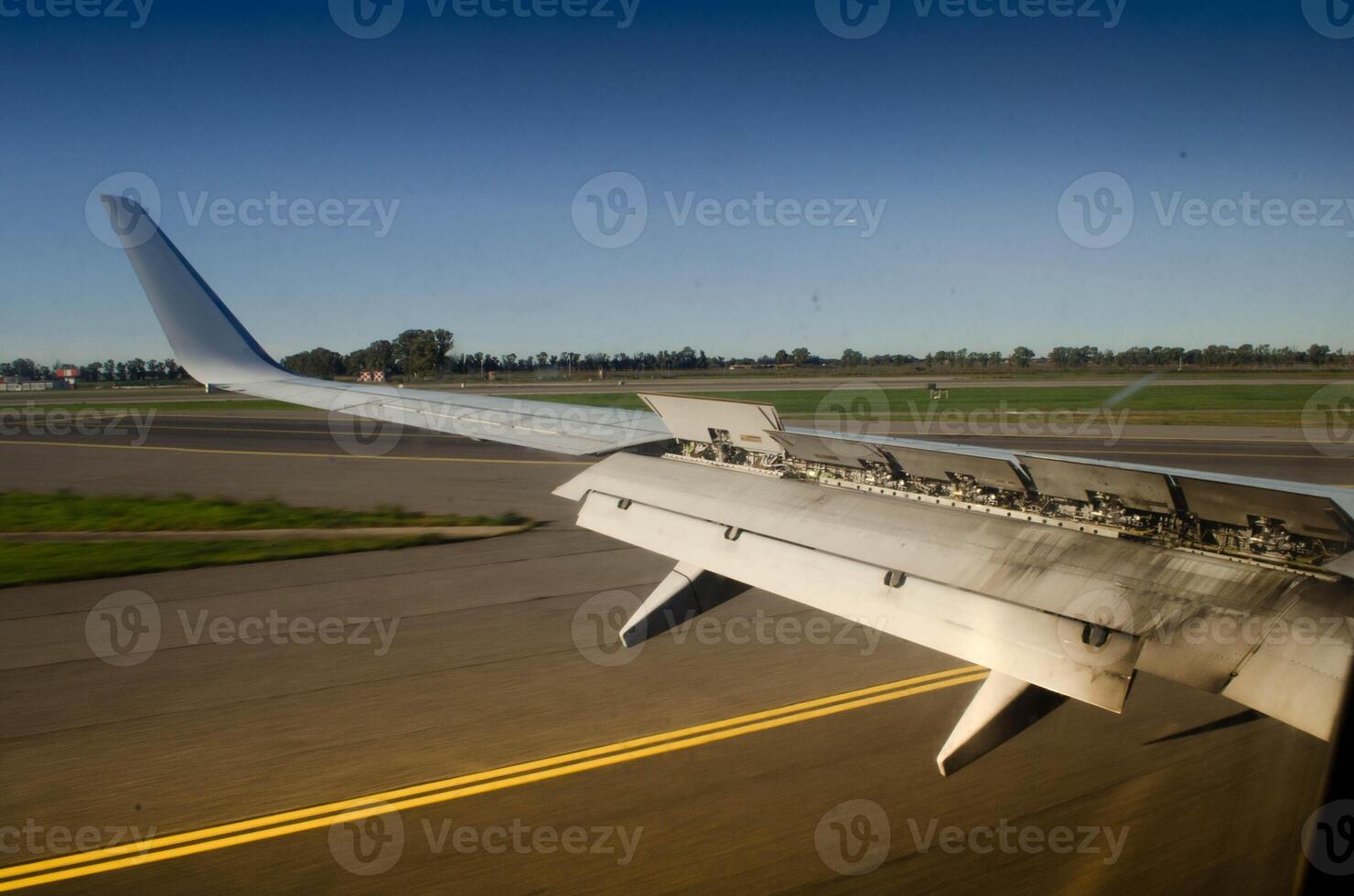Aircraft Wing with Extended Spoilers A Close Up View on the Runway photo
