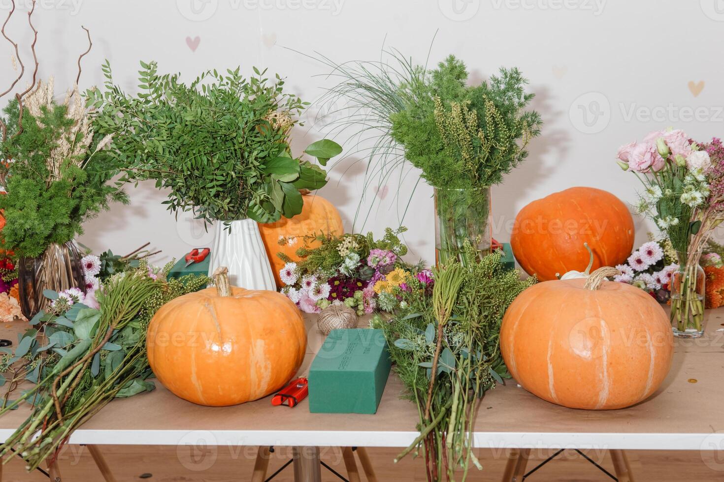 Flower arrangement in a pumpkin, autumn interior decor. Creating handmade autumn decor. photo